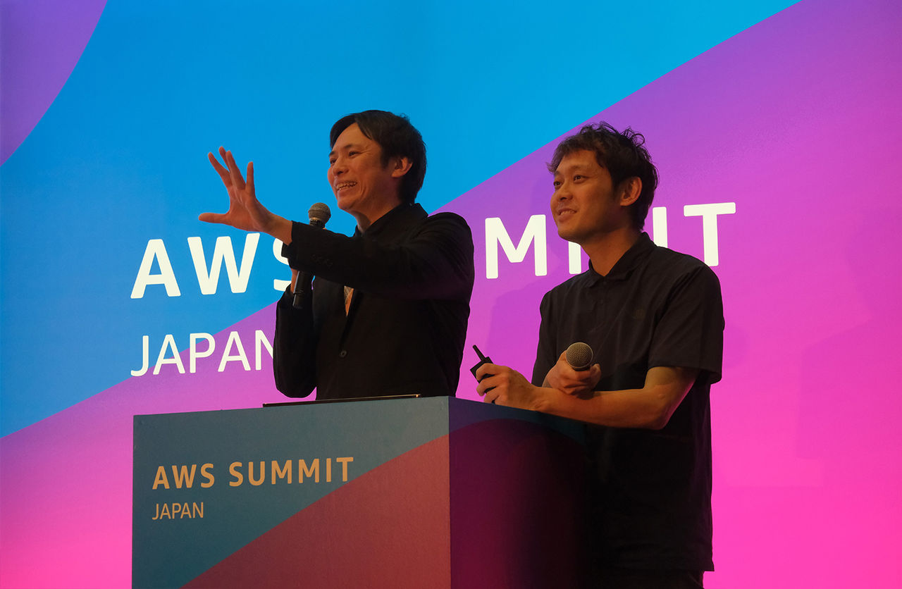 Image: Satoru Yamamoto speaking on stage.